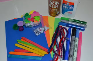 materials needed to make butterfly craft for kids including Foam Sheets Glue Popsicle Sticks Pipe Cleaners Pom-Poms Pens Glitter Glue Foam Stickers Googly Eyes