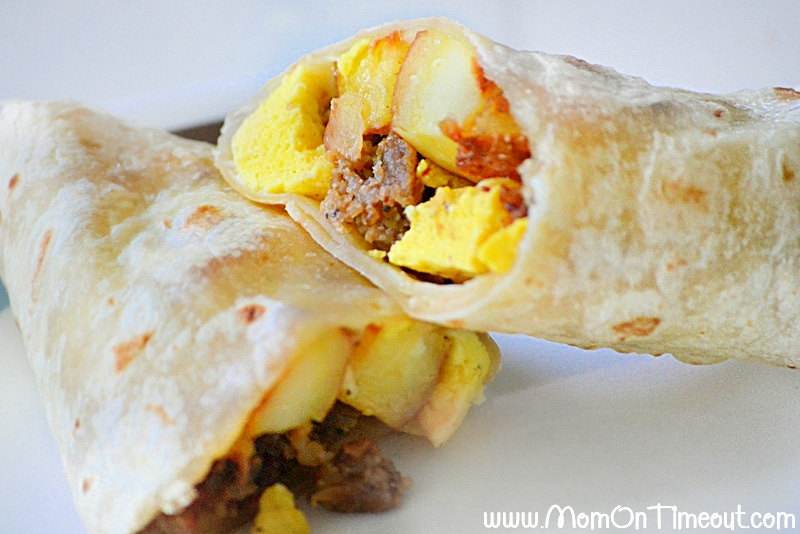 breakfast burrito cut in half on white plate