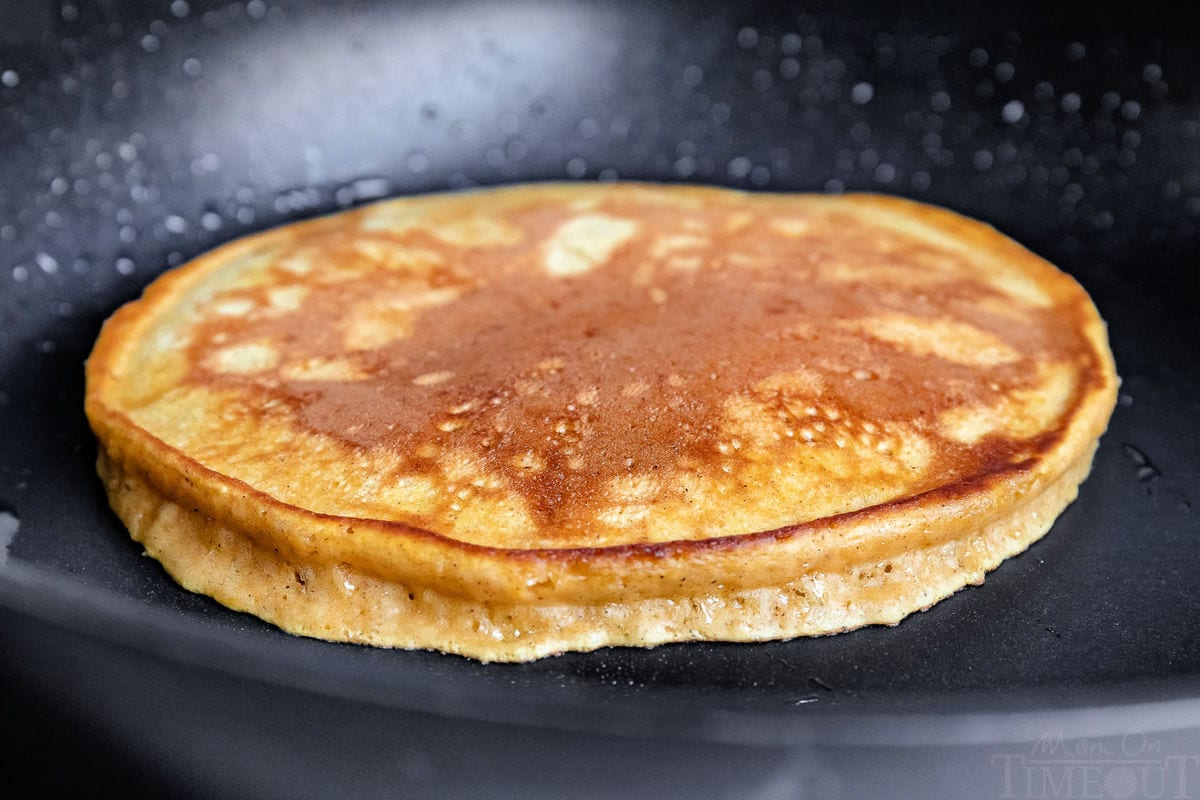 pumpkin pancakes being cooked on skillet