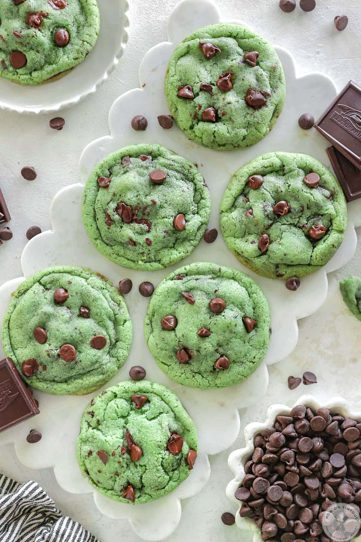 Close up look at chocolate chip and mint cookies on white marble board. 