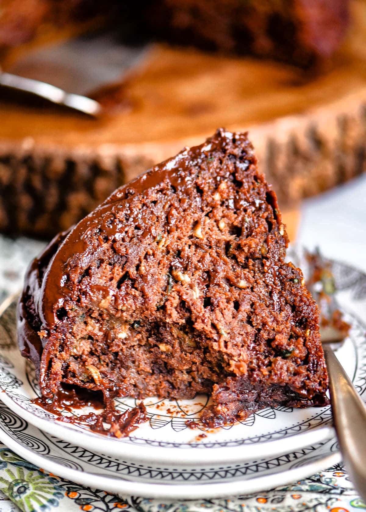 slice of cake with a couple bites taken sitting on a white small plate.