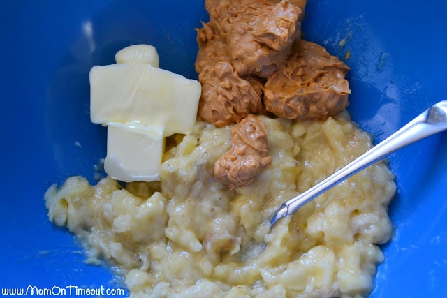mashed banana butter and chunky peanut butter in a blue mixing bowl