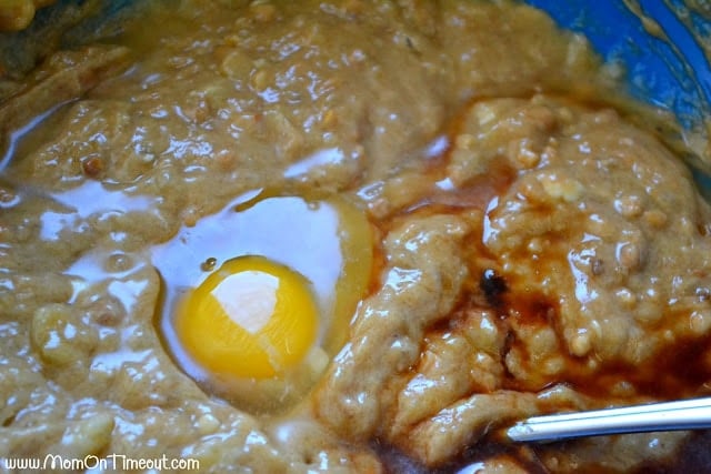 peanut butter banana bread batter with egg and vanilla extract on top