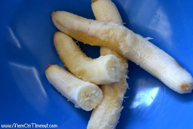 three bananas in a blue bowl