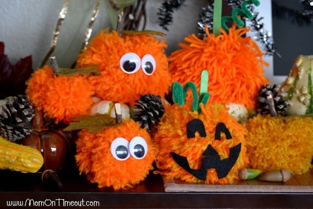 Make these Pom Pom Pumpkins with the kids this Halloween season! Super fun and SO easy too!  | MomOnTimeout.com