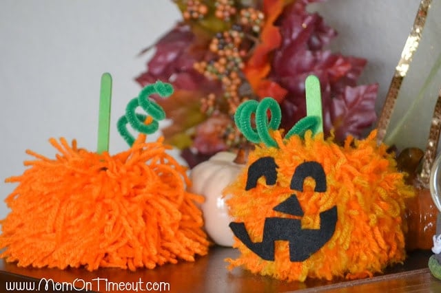 Make these Pom Pom Pumpkins with the kids this Halloween season! Super fun and SO easy too!  | MomOnTimeout.com