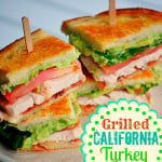 turkey club sandwich with avocado and bacon on small lunch plate