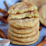 snickerdoodles stacked on blue board with top cookie broken in half text overlay at top square