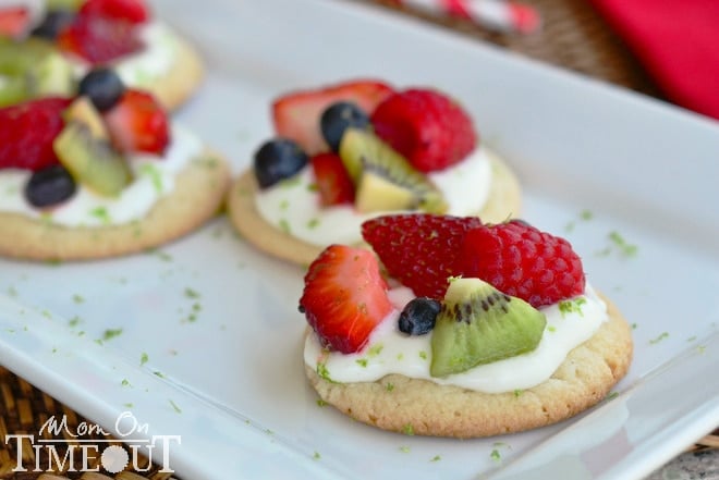 fruit basket sugar cookie pizzas on white tray with title overlay landscape view