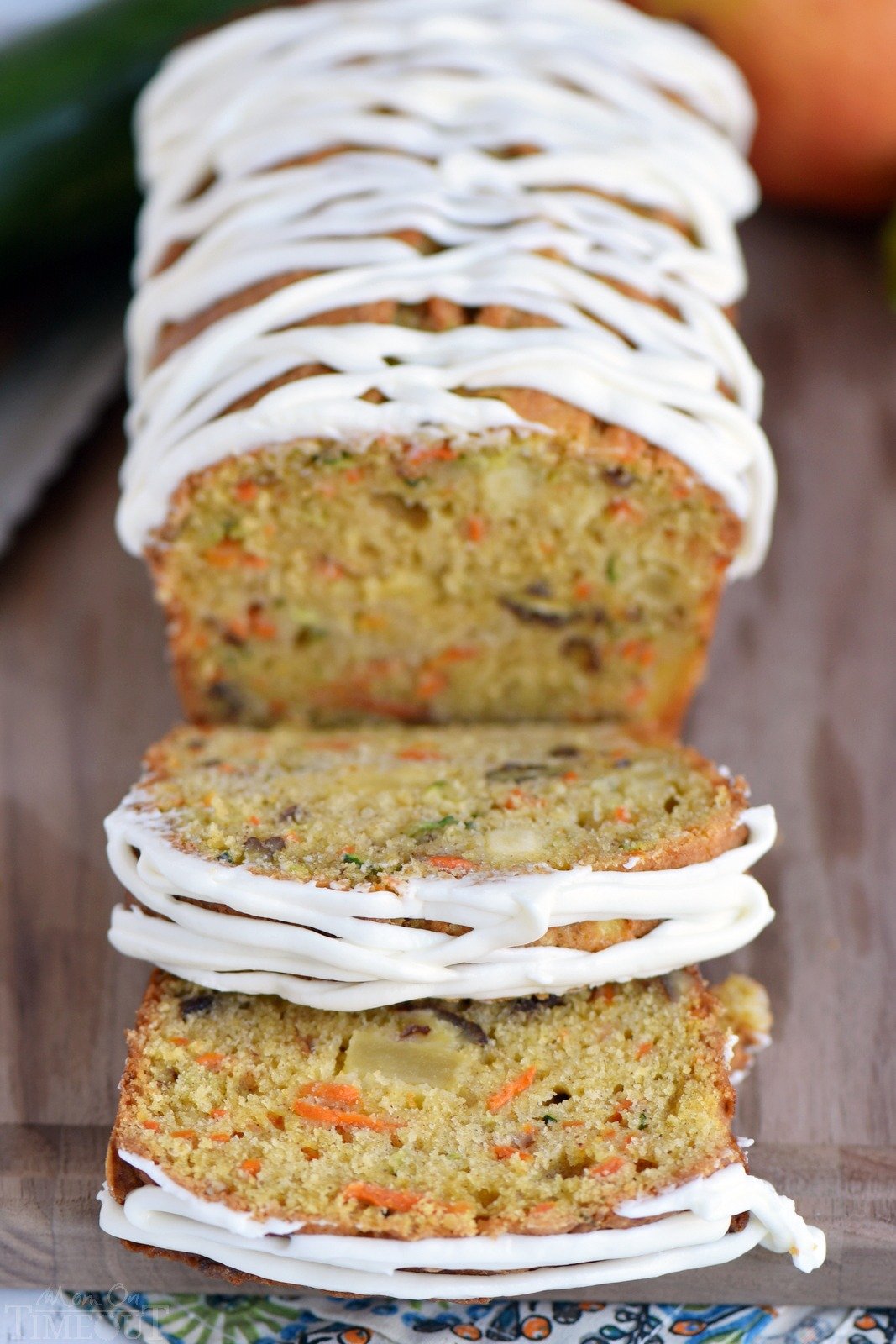 This Carrot Apple Zucchini Bread recipe is incredibly moist and flavorful! Vibrant colors from the carrot, apple, and zucchini makes this quick bread irresisitble!  Sure to be a new favorite! // Mom On Timeout