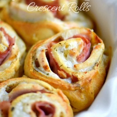 chicken cordon bleu crescent rolls baked in white pie dish with title overlay