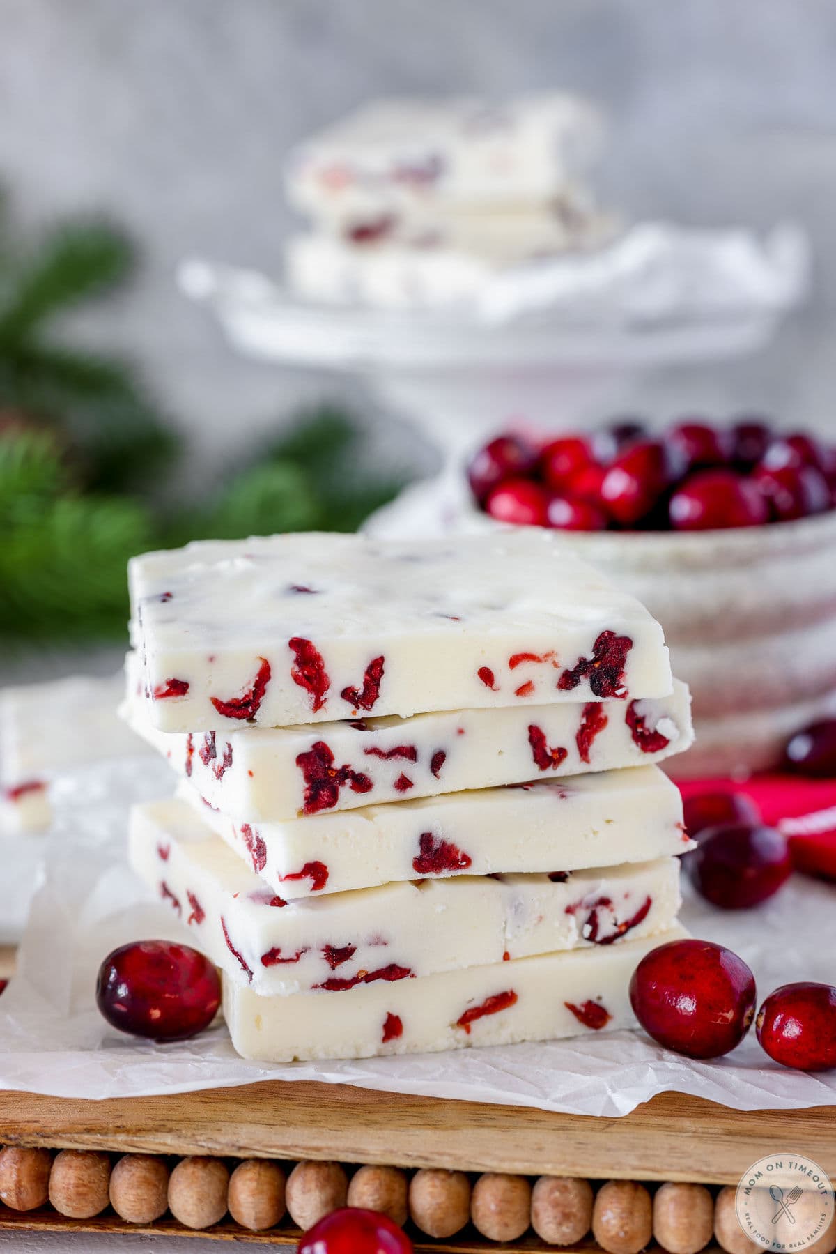 Five pieces of cranberry fudge stacked high, cut into large rectangles.