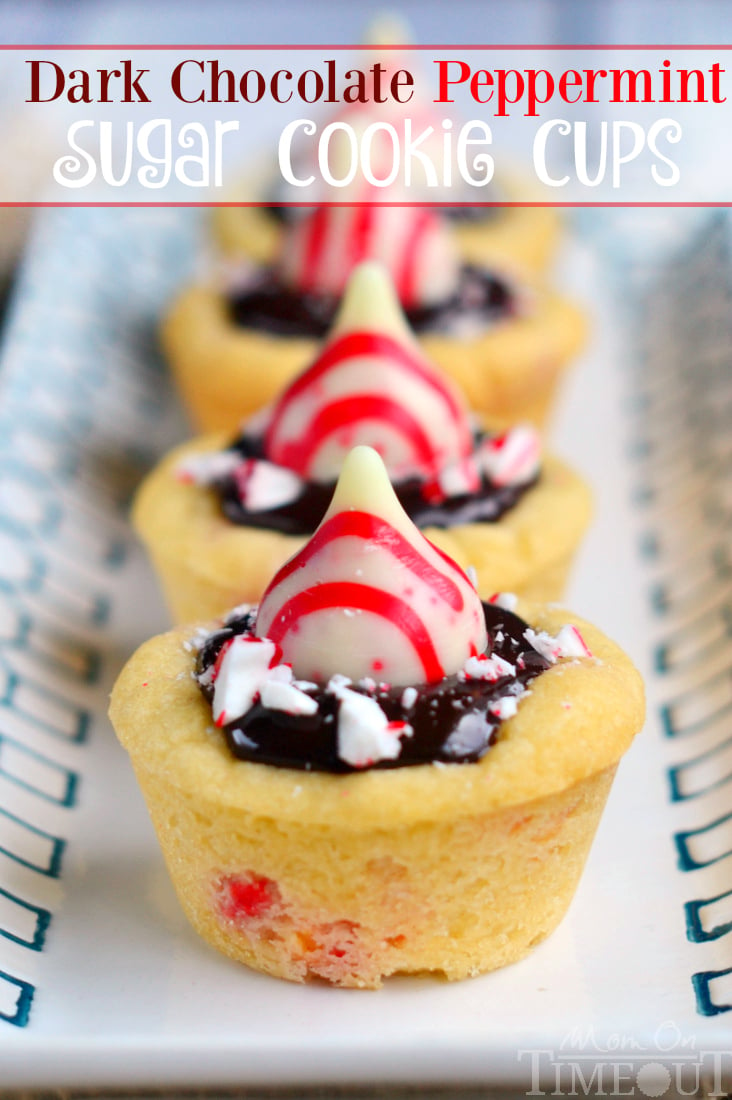 Dark Chocolate Peppermint Sugar Cookie Cups filled with chocolate ganache and topped with Candy Cane Hershey's Kisses. An easy treat that is perfect for the holidays!
