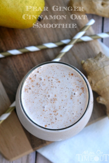 top down view of pear ginger oat smoothie in short glass with straws on the side and fresh pear and ginger next to it