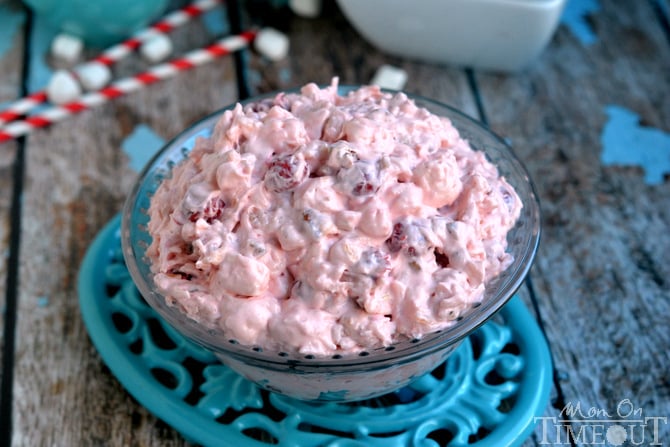 cherry fluff dessert salad sitting in bowl on blue trivet