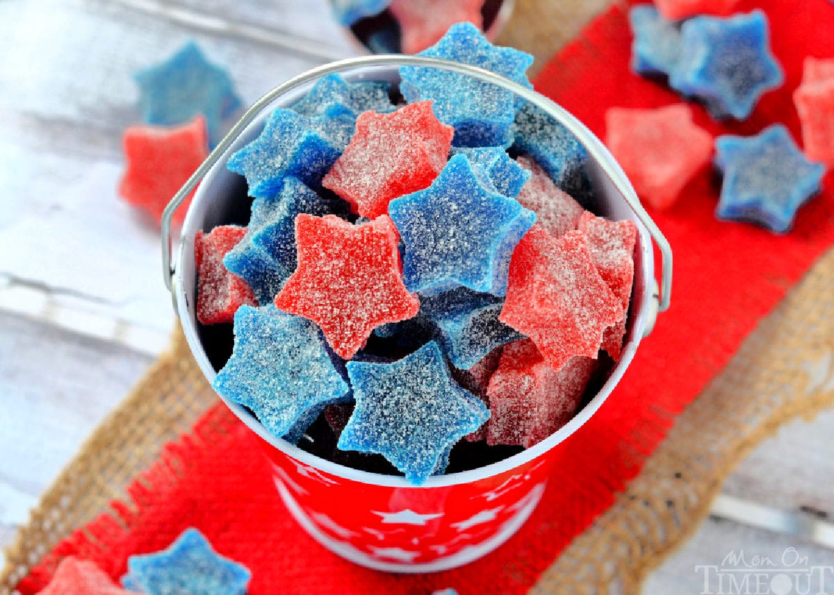Wide shot of homemade gumdrops cut into star shapes. Made with red and blue jello. 