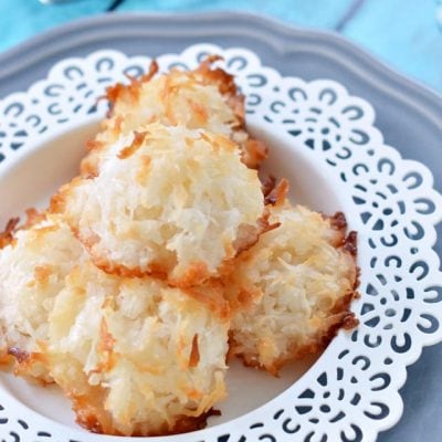 coconut macaroons on white plate with blue background