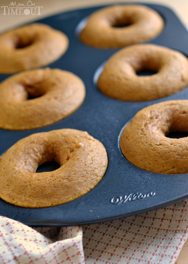 These easy Baked Pumpkin Spice Donuts with Maple Glaze are perfectly moist and bursting with flavor - the quintessential fall breakfast! | MomOnTimeout.com | #pumpkin #donut #doughnut #breakfast #recipe