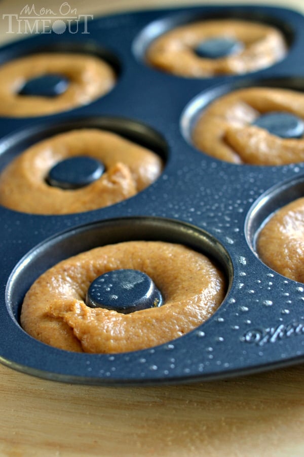 These easy Baked Pumpkin Spice Donuts with Maple Glaze are perfectly moist and bursting with flavor - the quintessential fall breakfast! | MomOnTimeout.com | #pumpkin #donut #doughnut #breakfast #recipe