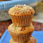banana nut muffins stacked on each other on blue napkin