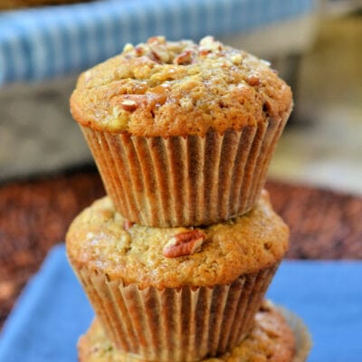 banana nut muffins stacked on each other on blue napkin