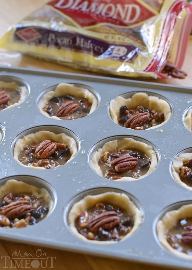 These Mini Chocolate Pecan Pies are a dream come true for the holidays! Sweet chocolate morsels are the perfect addition to traditional pecan pie and everybody loves this mini version! | MomOnTimeout.com | #dessert #Challenge Butter #PinaRecipeFeedaChild 