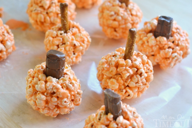 Fun and oh-so delicious, these Pumpkin Popcorn Balls are made with marshmallows for the ultimate soft and chewy treat! Perfect for Halloween and Thanksgiving! | MomOnTimeout.com | #recipe #Halloween Thanksgiving #kids