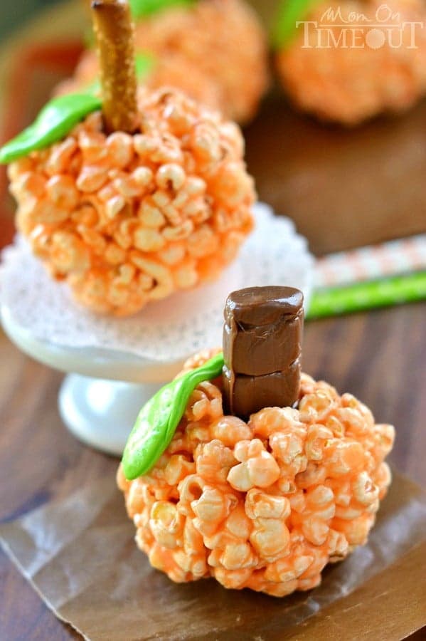 Fun and oh-so delicious, these Pumpkin Popcorn Balls are made with marshmallows for the ultimate soft and chewy treat! Perfect for Halloween and Thanksgiving! | MomOnTimeout.com | #recipe #Halloween Thanksgiving #kids