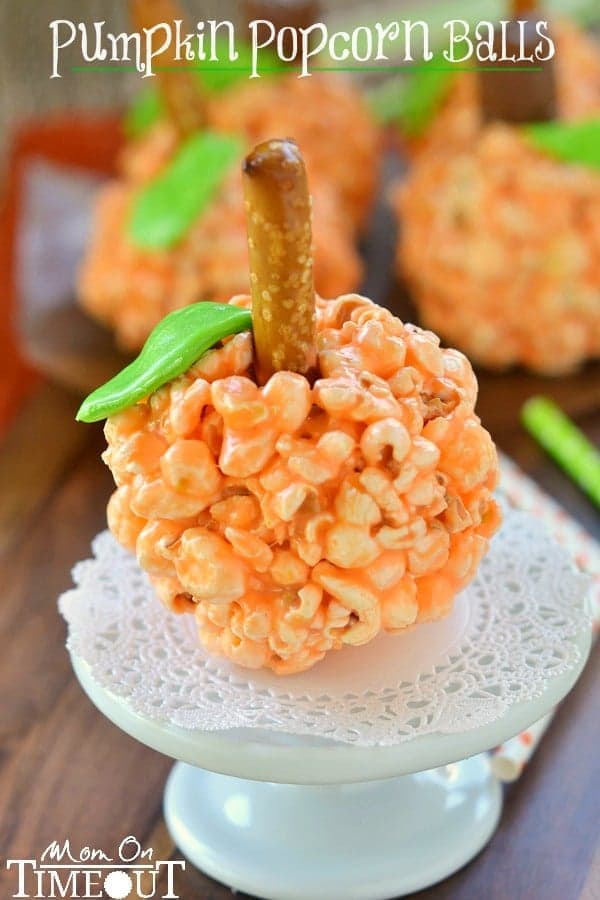 Fun and oh-so delicious, these Pumpkin Popcorn Balls are made with marshmallows for the ultimate soft and chewy treat! Perfect for Halloween and Thanksgiving! | MomOnTimeout.com | #recipe #Halloween Thanksgiving #kids