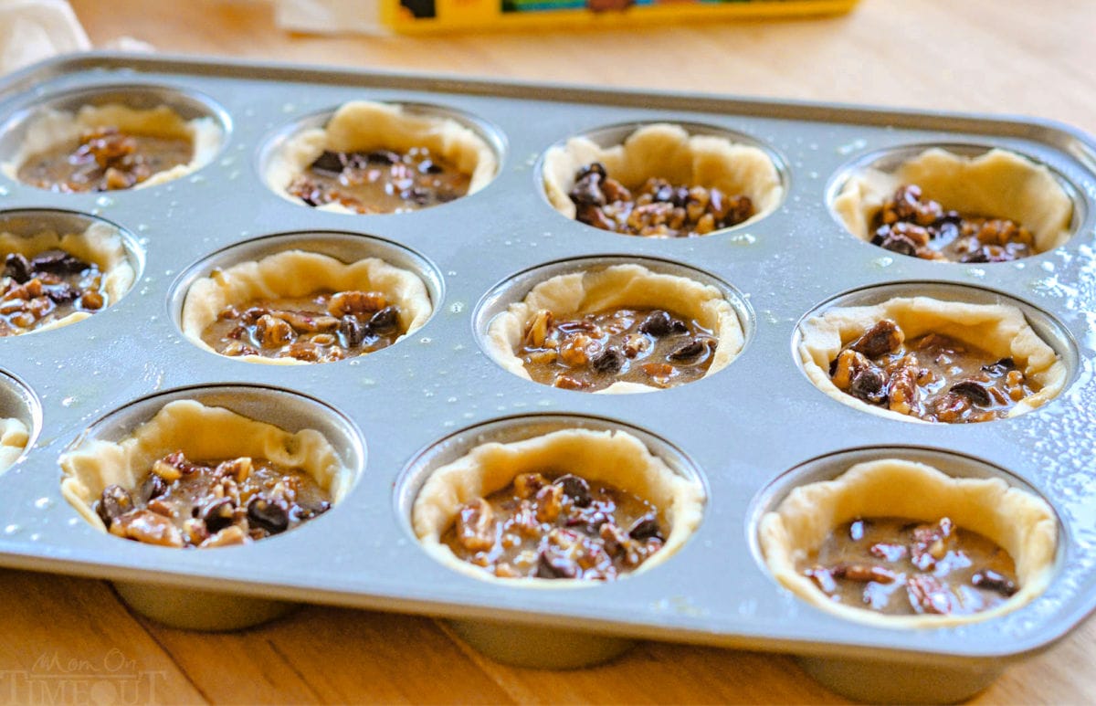 mini pecan pies in a muffin tin about to be baked.