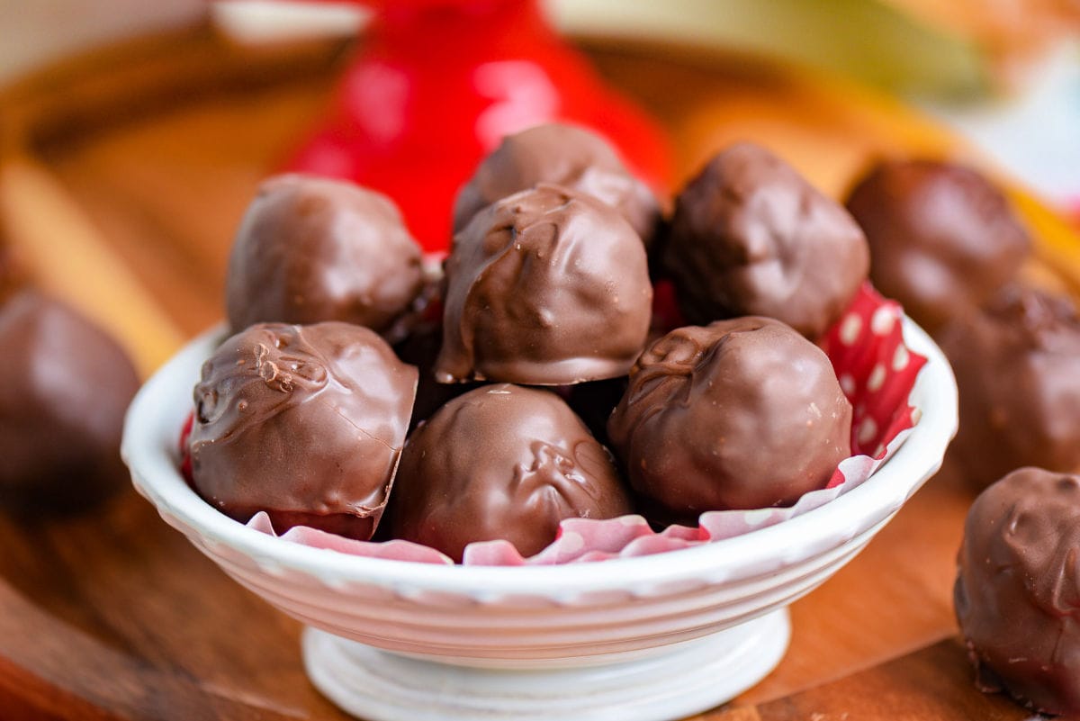 white bowl filled with martha washington candy coated in chocolate.