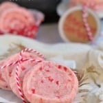 peppermint shortbread cookies with red and white twine laid on parchment with title overlay at top of image