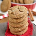 ginger molasses cookies in a stack on red burlap sitting on brown napking