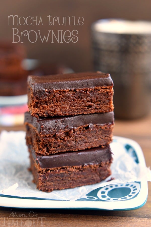 These decadent Mocha Truffle Brownies are just what your sweet tooth is craving. Rich mocha brownies are topped with a decadent chocolate ganache frosting and baked to perfection. All you need is a cold glass of milk! | MomOnTimeout.com | #chocolate #brownie #mocha #dessert