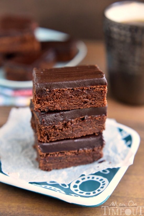 These decadent Mocha Truffle Brownies are just what your sweet tooth is craving. Rich mocha brownies are topped with a decadent chocolate ganache frosting and baked to perfection. All you need is a cold glass of milk! | MomOnTimeout.com | #chocolate #brownie #mocha #dessert