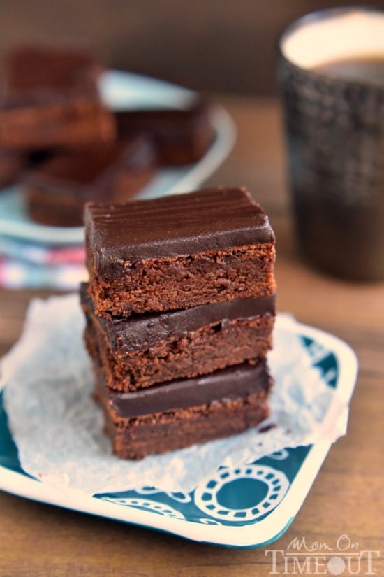 These decadent Mocha Truffle Brownies are just what your sweet tooth is craving. Rich mocha brownies are topped with a decadent chocolate ganache frosting and baked to perfection. All you need is a cold glass of milk! | MomOnTimeout.com | #chocolate #brownie #mocha #dessert