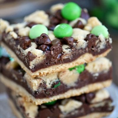 3 stacked chocolate mint fudge bars with green candies.