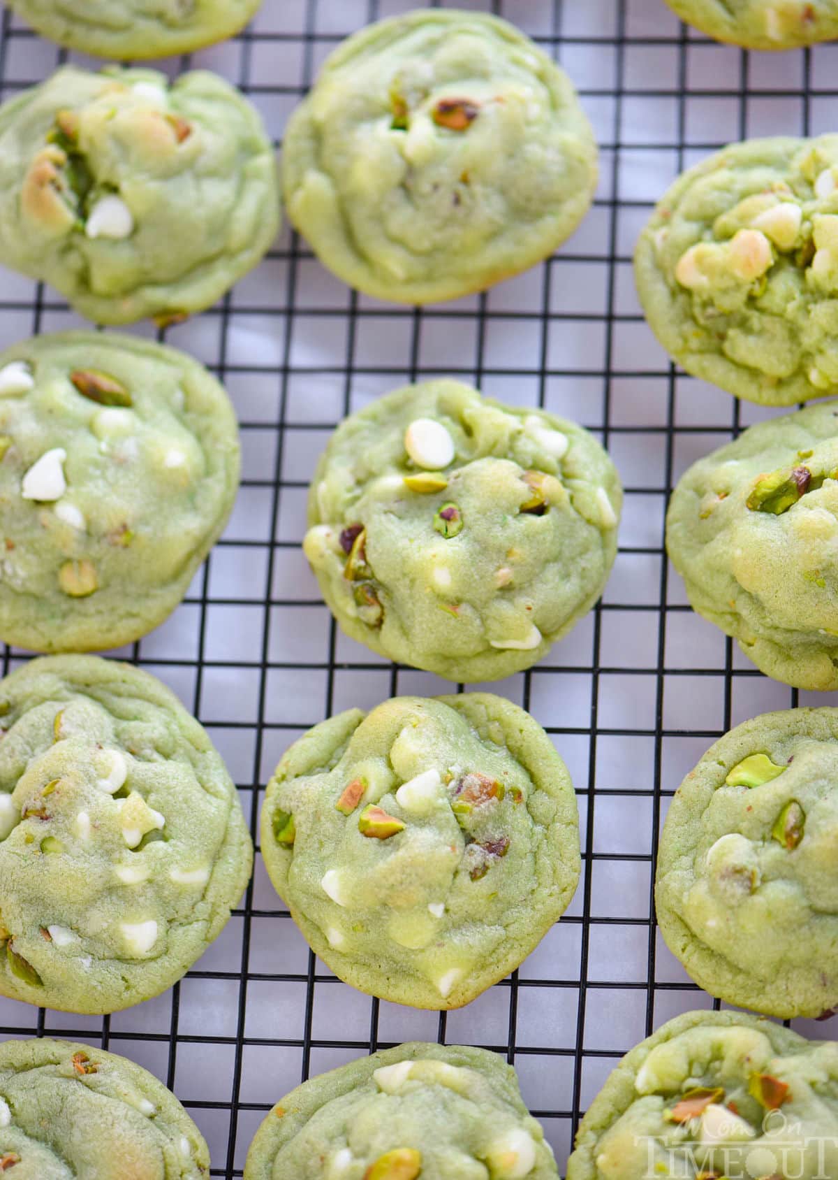 top down view of pistachio pudding cookies on a cooling rack.