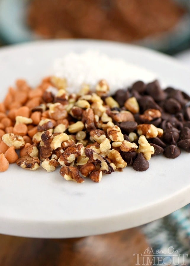 These Magic Brownie Cookies are packed full of flavor - coconut, butterscotch, walnuts, and of course, CHOCOLATE! This easy to make dessert will be a hit at your next party - no one can eat just one! | MomOnTimeout.com