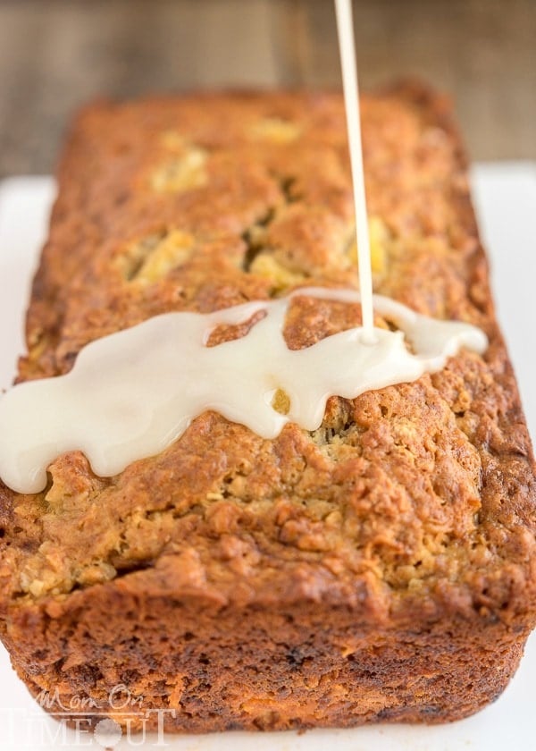 This easy Pina Colada Banana Bread recipe is our new favorite! Super moist and delicious banana bread topped with a pineapple-rum glaze and toasted coconut! | MomOnTimeout.com
