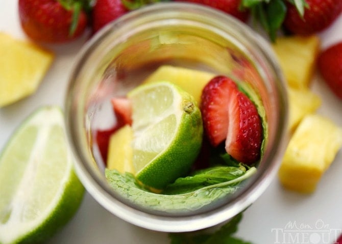 Perfectly cool, sweet, and SO refreshing, this fruit-infused Pineapple Strawberry Mojito cocktail has it all! | MomOnTimeout.com