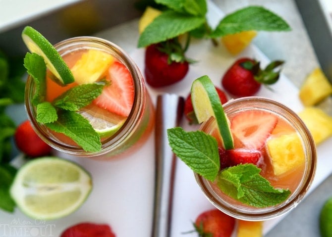 Perfectly cool, sweet, and SO refreshing, this fruit-infused Pineapple Strawberry Mojito cocktail has it all! | MomOnTimeout.com