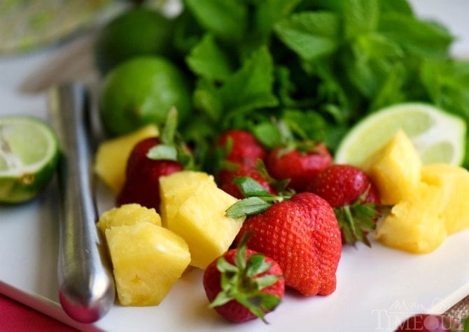 Perfectly cool, sweet, and SO refreshing, this fruit-infused Pineapple Strawberry Mojito cocktail has it all! | MomOnTimeout.com