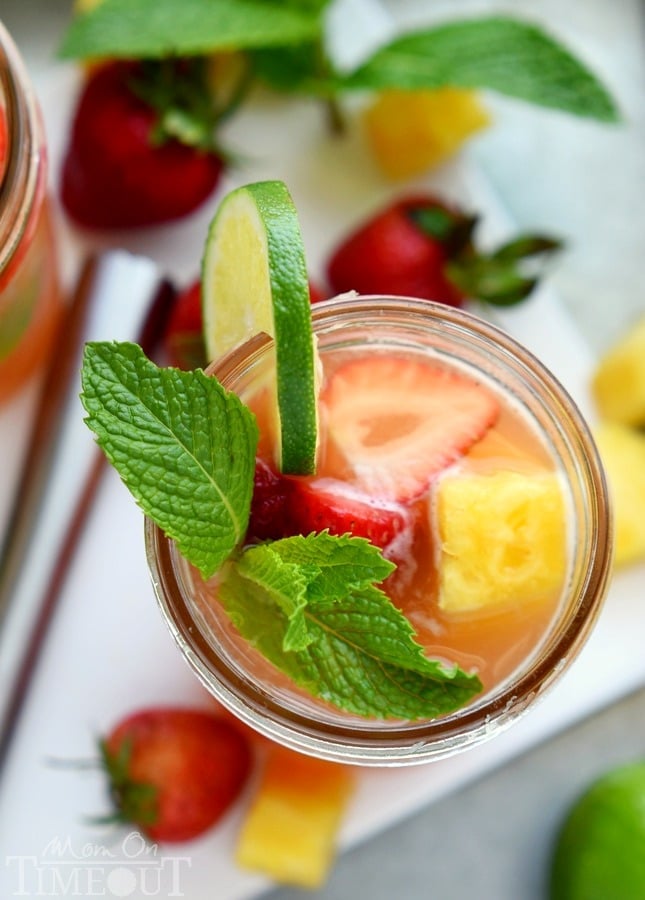 Perfectly cool, sweet, and SO refreshing, this fruit-infused Pineapple Strawberry Mojito cocktail has it all! | MomOnTimeout.com