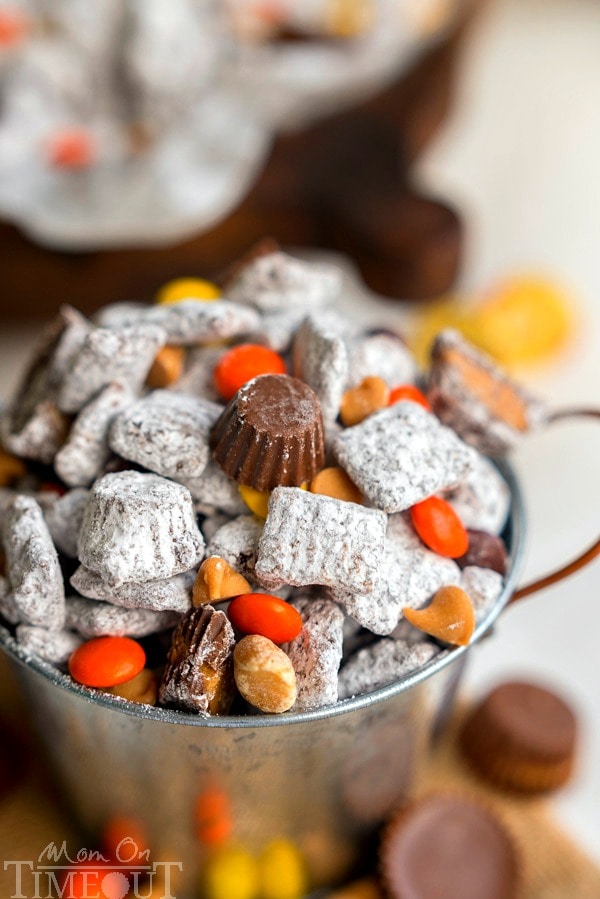 Reese's Muddy Buddies are taken to the next level in this amazingly delicious and easy dessert recipe! Reese's all the things! Reese's Pieces, Reese's Peanut Butter Chips, Reese's Minis, and Reese's Miniatures are all perfectly happy sharing space in this powdered sugar coated wonder land known as Muddy Buddies. | MomOnTimeout.com