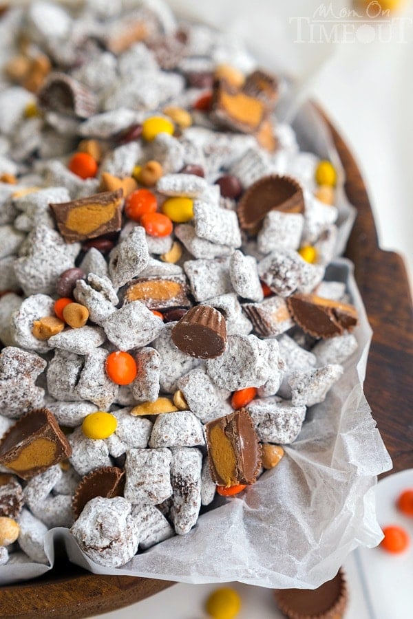 Reese's Muddy Buddies are taken to the next level in this amazingly delicious and easy dessert recipe! Reese's all the things! Reese's Pieces, Reese's Peanut Butter Chips, Reese's Minis, and Reese's Miniatures are all perfectly happy sharing space in this powdered sugar coated wonder land known as Muddy Buddies. | MomOnTimeout.com