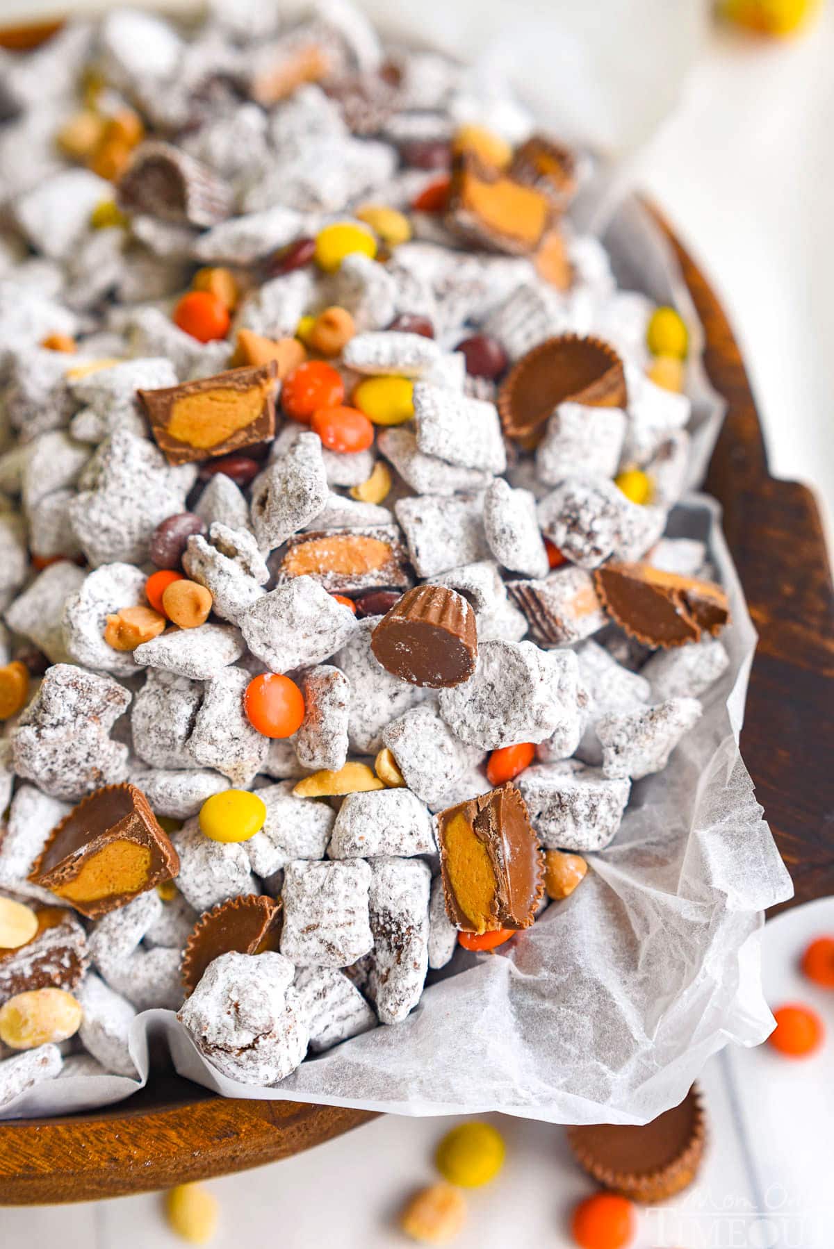 Overhead shot of wood bowl filled with muddy buddies and reeses candy.