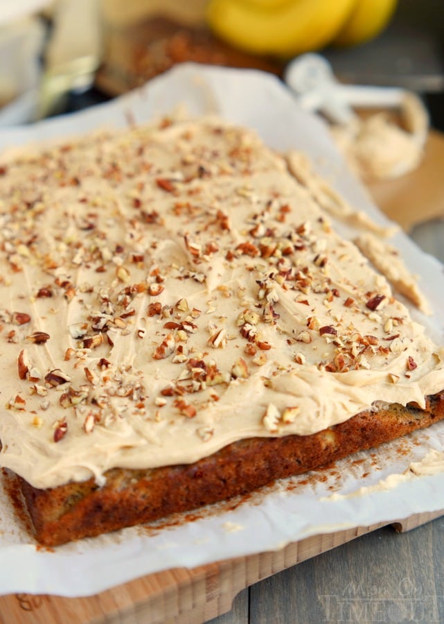 sheet cake banana cake frosted on parchment paper and cutting board