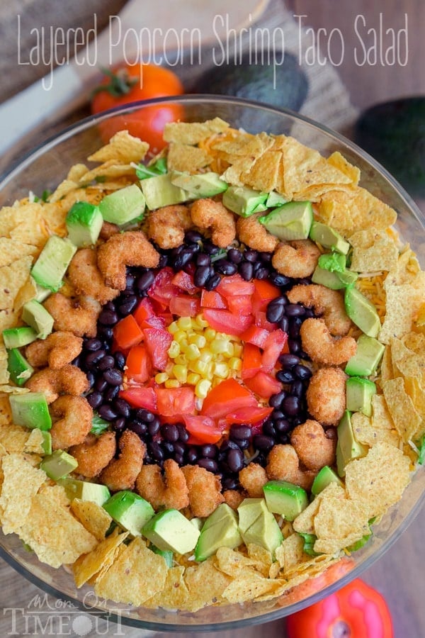 This delicious Layered Popcorn Shrimp Taco Salad is perfect for an easy, breezy summer time meal! Layers and layers of flavor make this a dinner the whole family will love! | MomOnTimeout.com | #dinner #salad #ad