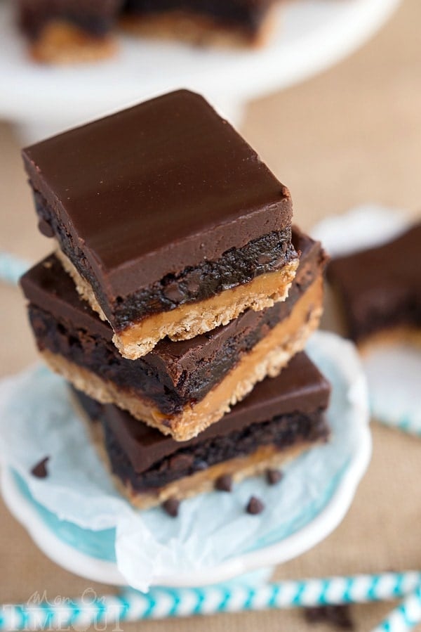 Four layers of intense flavor will have you craving these Oatmeal Caramel Truffle Brownies day and night! An oatmeal cookie crust topped with rich caramel, fudgy brownie and ganache frosting. Welcome to paradise. | MomOnTimeout.com | #IDelightIn10 #recipe 